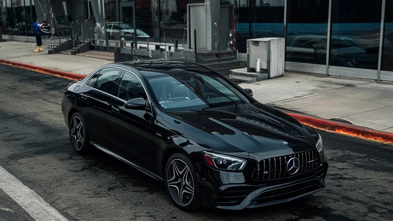 From above. black 2023 Mercedes Benz E-Class in front of JFK airport