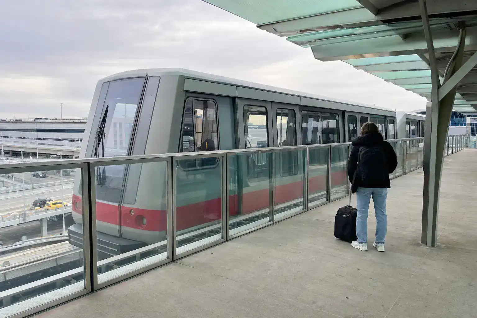 10 Things to Know Before Flying Into JFK Airport (2026) 3 JFK AirTrain at an elevated terminal station platform