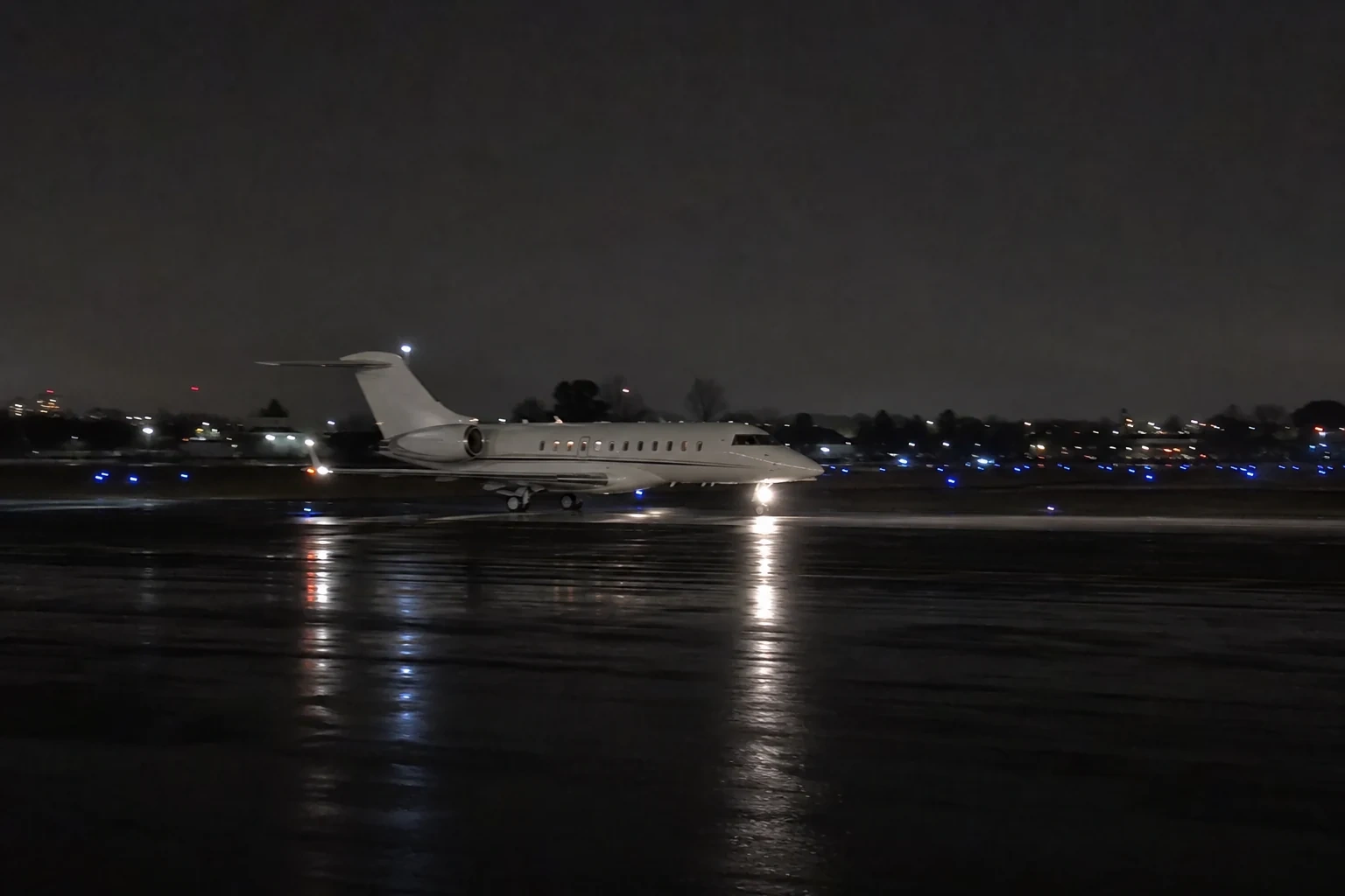 Private jet departing Teterboro Airport at night under noise-abatement procedures