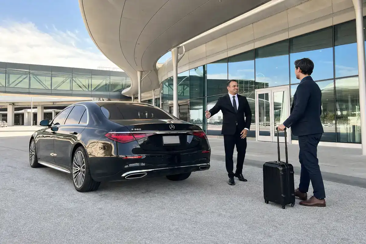 Car service from Harrison to LaGuardia Airport, black sedan at the terminal