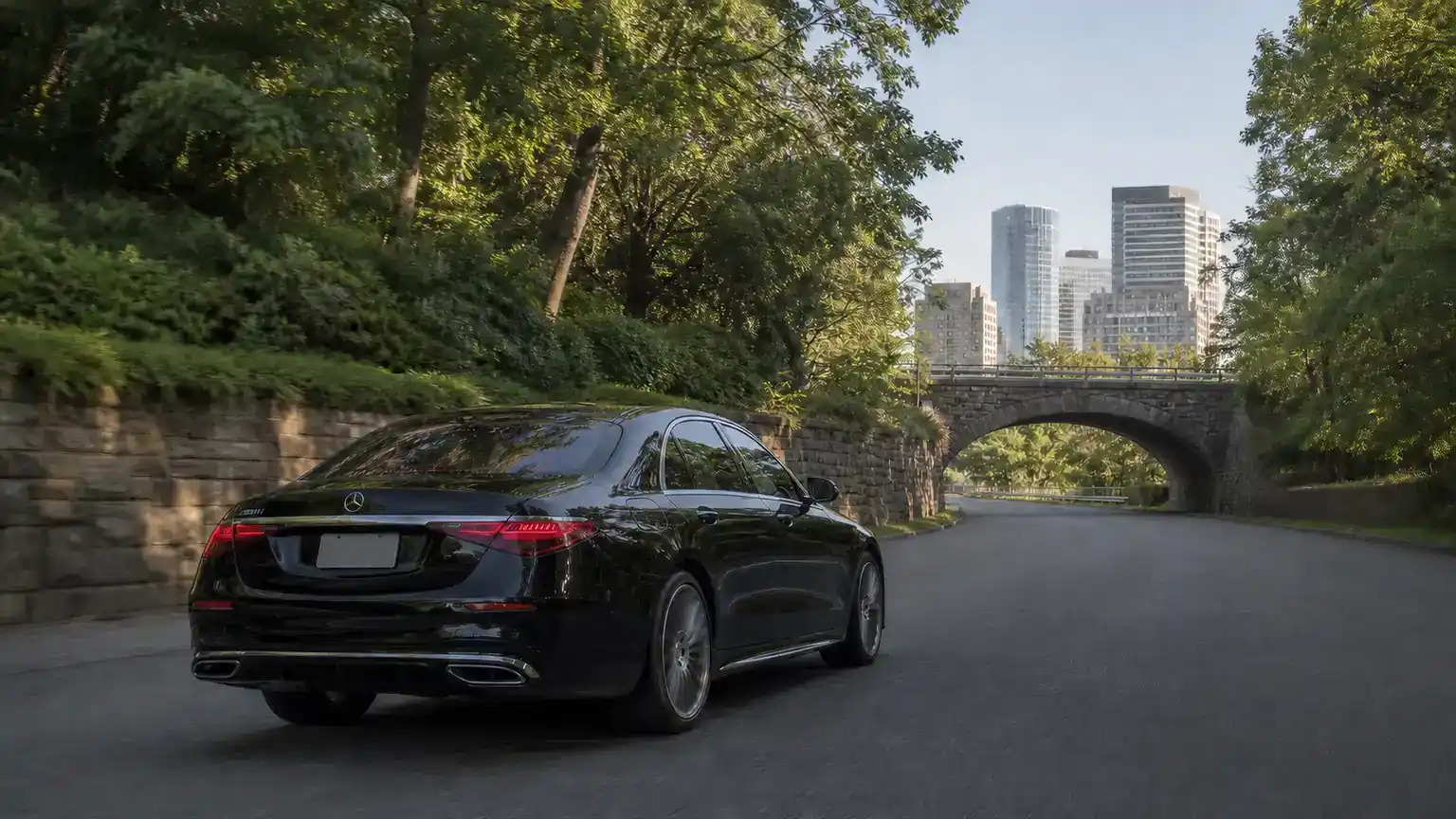White Plains Car Service 7 Black Mercedes sedan on a tree-lined Westchester parkway heading toward White Plains