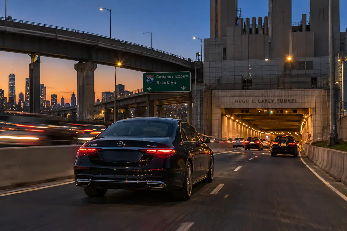 Black sedan entering the Hugh L. Carey Tunnel from Red Hook on a car service trip from Brooklyn to Newark Airport